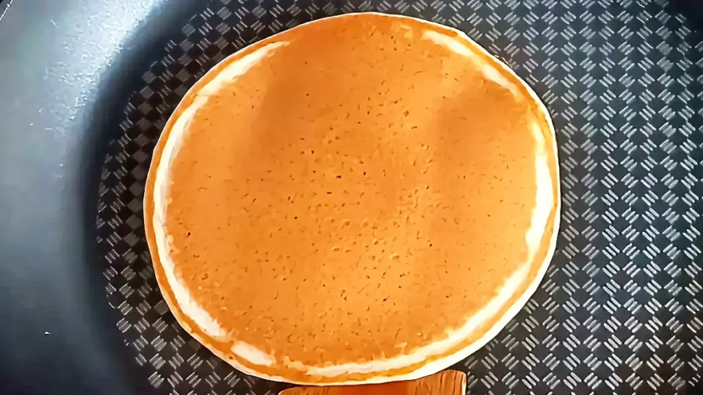 Golden-brown fluffy honey pancakes recipe flipped in pan