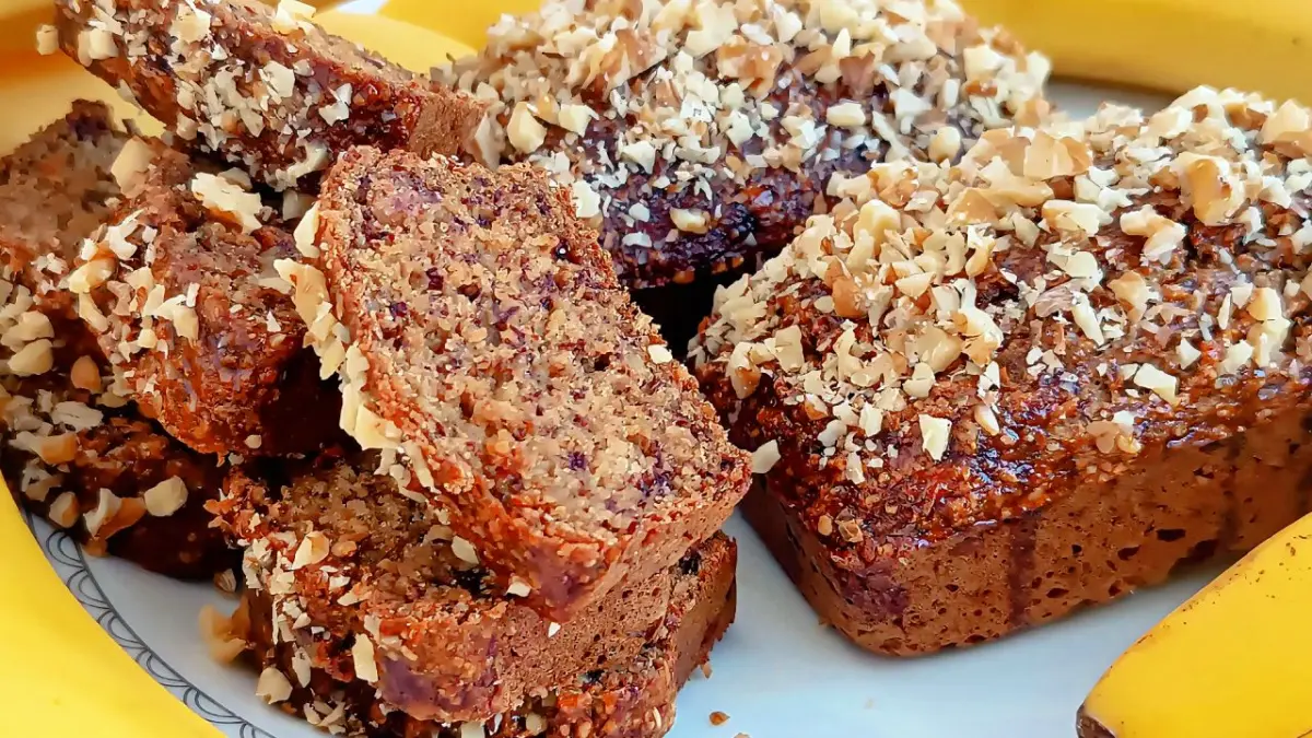 Healthy banana oat bread sliced into pieces on a wooden board